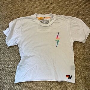 white AV shirt with neon lightning bolt on side